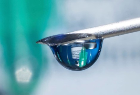 Macro image Covid vaccine, a drop of Moderna vaccine hangs on a vaccine needle
