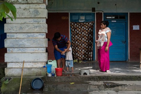 Meitei community man stays in a makeshift shelter after a mob burn their houses during an ethnic