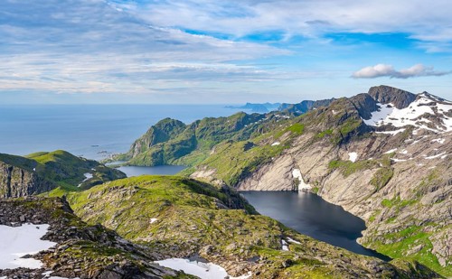 Mountain landscape with steep rocky peaks and lake FJerddalsvatnet and Stuvdalsvatnet, sea view,