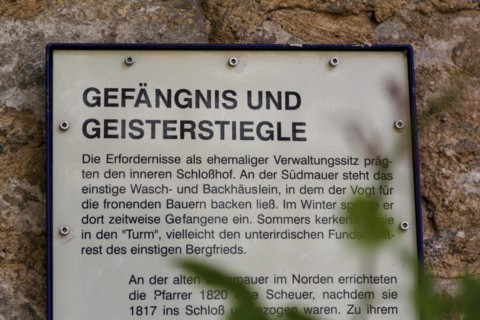 Gomaringen Castle, information board on former bakehouse and washhouse, prison in castle courtyard,