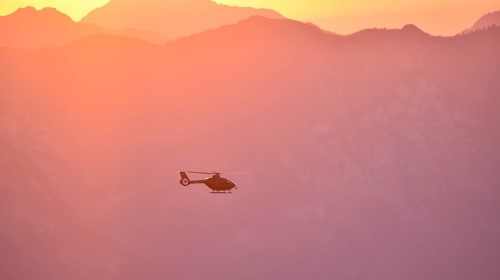 Rescue helicopter Christoph in flight in the evening over the Berchtesgaden Alps, Bavaria, Germany,