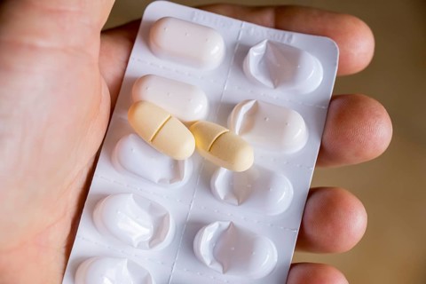 Hand holding a blister pack with tablets