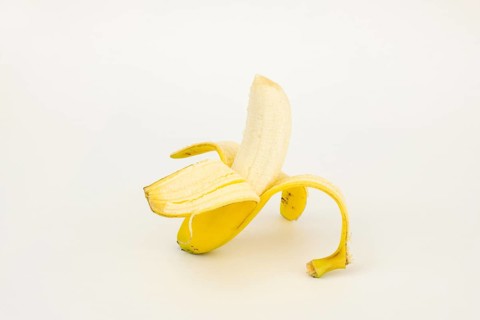 Half peeled banana, studio shot, white background, healthy diet