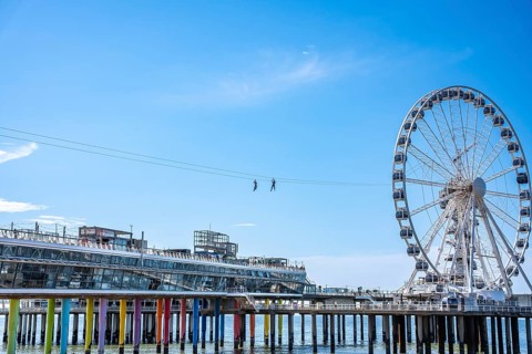 Two people on the Zip Line above the pier, The Hague, Netherlands