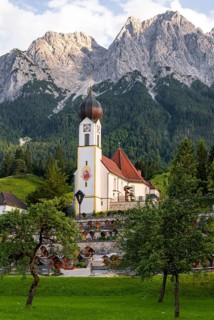 Cemetery and church of St. John the Baptist, mountain peak of the Wetterstein Mountains at the