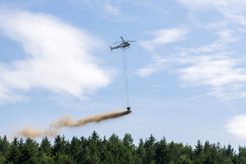 Symbolic image, climate change, helicopter, helicopter spreading finely painted limestone and wood