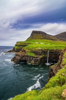 Gasadalur waterfall into the ocean, Vagar, Faroe islands, Denmark, Europe