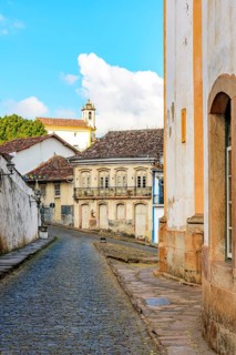Cobbled streets between historic baroque churches and colonial style houses in the city of Ouro