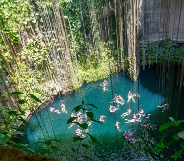People swimming in limestone sinkhole pool, Cenote Ik kil, Pisté, Yucatan, Mexico, Central America