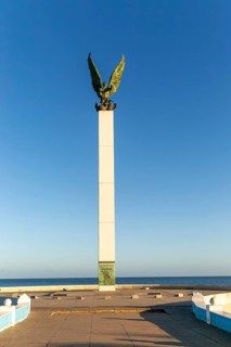 Sculpture of winged Mayan Angel on tall column, the seafront Malecon, Campeche city, Campeche