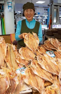Korean market woman, 65, with dried grouper, Yeosu Fish Market, Yeosu, Jeollanam-do Province, South