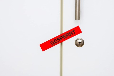 Locked, tape on taped office cupboard door