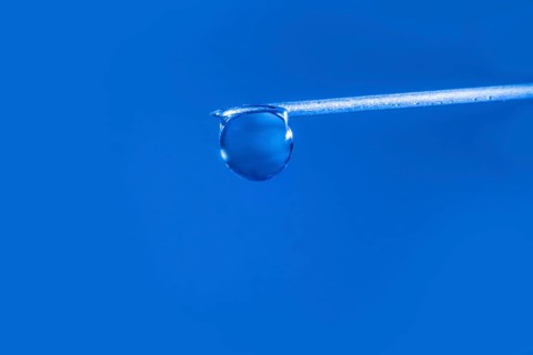 Macro image Covid vaccine, a drop of Moderna vaccine hangs on a vaccine needle