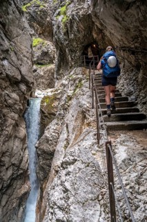 Hiker in a gorge, Hammersbach flows through Höllentalklamm, near Garmisch-Partenkirchen,