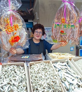 Korean market woman with dried squid, Yeosu fish market, Yeosu, Jeollanam-do province, South Korea,