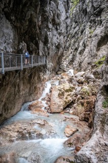 Hiker in a gorge, Hammersbach flows through Höllentalklamm, near Garmisch-Partenkirchen,