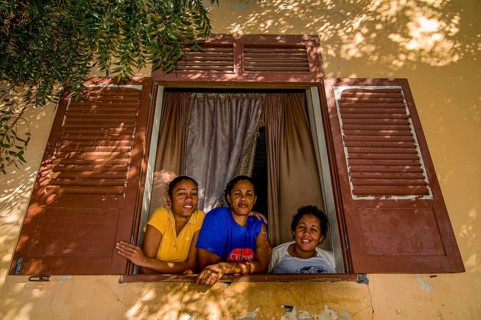 Young women looking out of window. San Felipe. Vulcano Fogo. Fogo. Cabo Verde. Africa