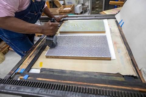 Detroit, Michigan, Amos Kennedy works in his letterpress printing shop. Kennedy prints posters and