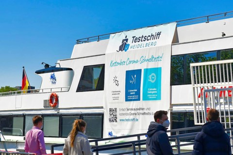 Heidelberg, Germany, April 2021: People waiting at Corona virus test station called 'Testschiff' on