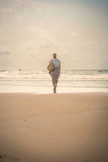 Woman on the beach in the evening sun, Zandvoort, Netherlands