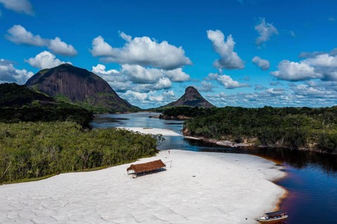 Black river and white sand beach before the granite hills, Cerros de Mavecure, Eastern Colombia