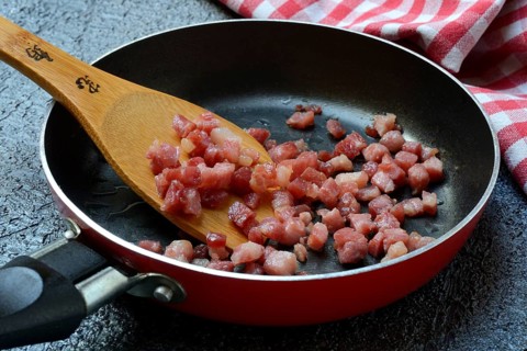 Fried bacon cubes in pan, bacon