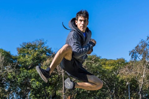 Martial arts fighter jumping in fly outdoors