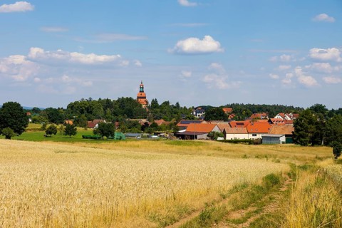 On the edge of Eisenberg, you can look across ripe cornfields to the Moritzburg Evangelical