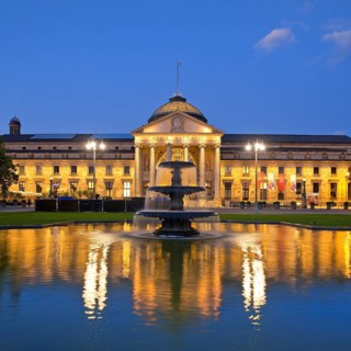 Illuminated spa hotel and Casino in the evening with cascade fountain, Wiesbaden, Hesse, Germany,