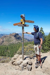 Hiker looking at the signpost in Parque Rural del Nublo, Las Palmas province, Gran Canaria, Canary