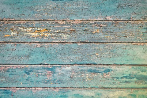 Grunge background with wooden dark teal blue colored old weathered planks with chipped paint
