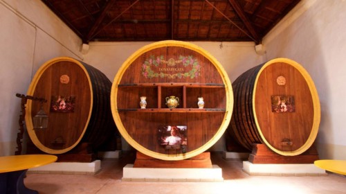 Three large wine barrels, artistically painted and used as wall decoration in a wine cellar, Donna