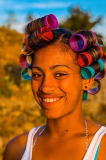 Local woman with curling irons is laughing. Fogo. Cabo Verde. Africa