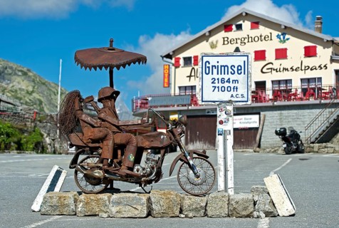 Biker couple, metal sculpture on the Grimsel Pass in front of the Berghotel Alpenlodge Grimselpass,