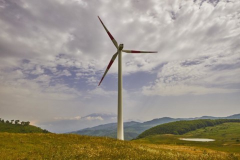 Single wind generator, meadow, green hills, cloudy blue sky, Nebrodi National Park, Sicily, Italy,