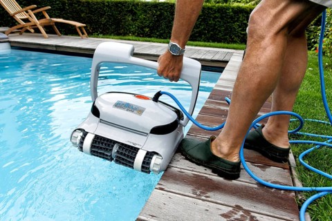 Cleaning robot ensures clear water and cleanliness in private swimming pool, Germany, Europe