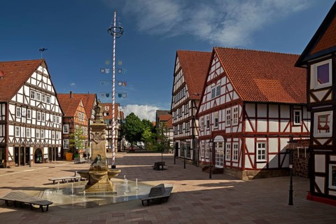 Market square with market fountain and maypole in the historic old town with many half-timbered