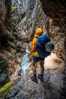 Hiker in a gorge, Hammersbach flows through Höllentalklamm, near Garmisch-Partenkirchen,