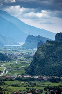View into the Sarca Valley towards Lake Garda with rocks of Castello di Arco, Garda Mountains,