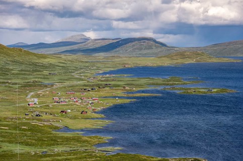Road and red houses by a large lake, Fjell, barren mountain landscape, Oystre Slidre, Jotunheimen
