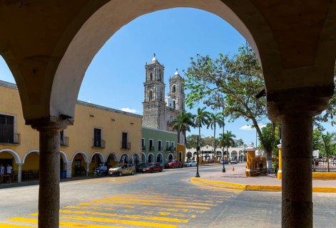 View to church from colonnaded walkway on main square, Spanish colonial architecture, Valladolid,