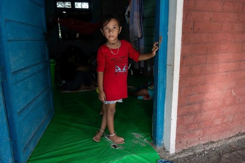 Meitei community man stays in a makeshift shelter after a mob burn their houses during an ethnic