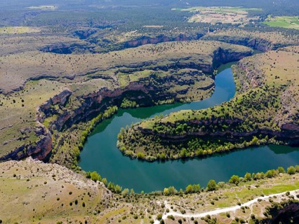 Expansive view of a river winding through deep gorges and hilly landscape, aerial view, gorge,