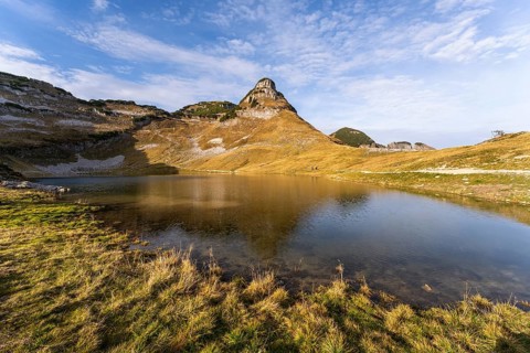 Lake Augstsee and the Atterkogel mountain on the Loser. Autumn, good weather, blue sky. Reflection.