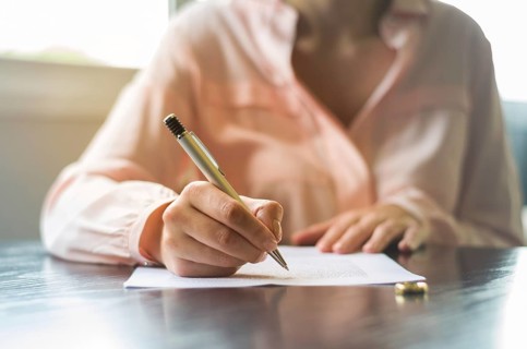 Great concept of divorce, end of relationship, young woman signing divorce agreement