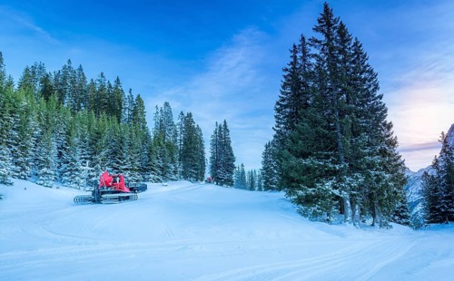 Winter scenery with lots of snow over the forestry roads in the Austrian Alps mountains and two