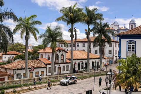 View to traditional houses and palm tree lined street in historic center of Diamantina on a sunny