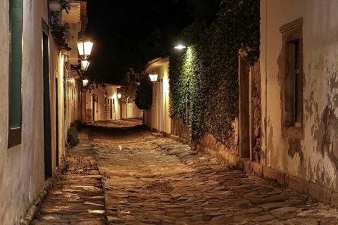 Atmospheric night view of illuminated street and buildings in historical center of Paraty, Brazil,