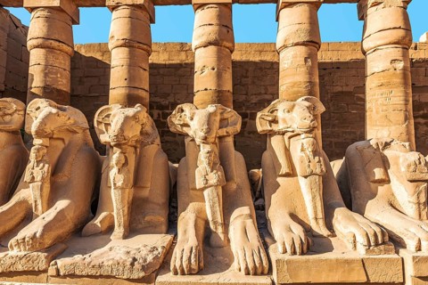 Ruined statues of sphinxes near columns in Karanak temple