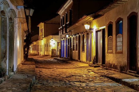 Atmospheric night view of illuminated street and buildings in historical center of Paraty, Brazil,